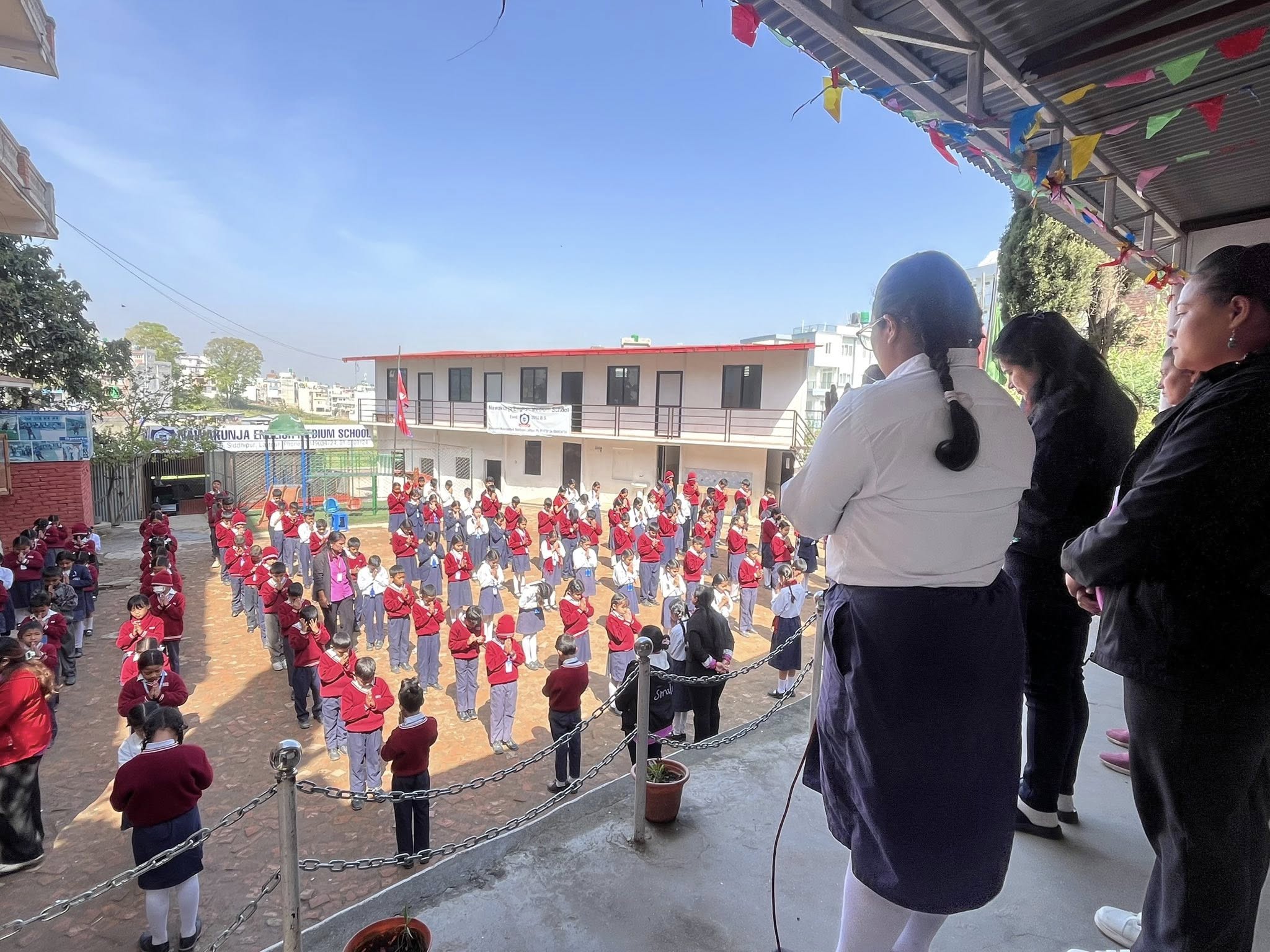 Morning assembly at Nawakunja — aerial view of students in formation